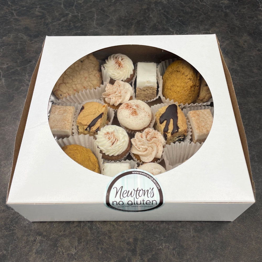 A box of assorted bakery treats, including cookies, bars, and mini cupcakes, labeled as 'Newton's No Gluten'.
